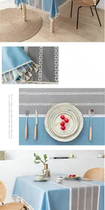 Detail of Nordic blue and grey PVC tablecloth with geometric patterns and white tassels