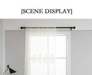 Detail of elegant beige lace curtain with floral embroidery on a black metal rod