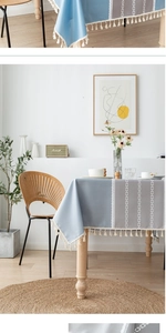 Detail of waterproof tablecloth with lace border, geometric pattern and elegant tassels