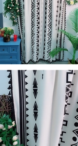 Detalle de cortina bohemia de lino con estampados geométricos negros y flecos de borlas