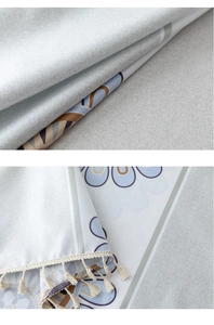 Detail of waterproof tablecloth with Nordic floral print and white tassel edges