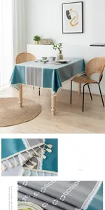 Close-up of green waterproof PVC tablecloth with delicate white lace and tassel details