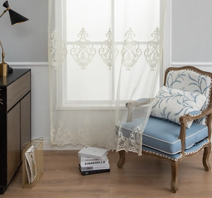Detail of elegant ivory lace sheer curtain featuring intricate baroque floral embroidery