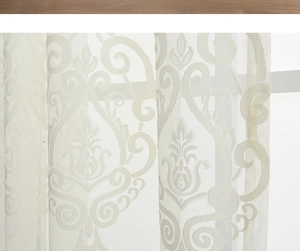 Detailed close-up of white sheer curtain with elegant Damascus embroidered patterns
