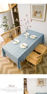 Detail of blue plaid tablecloth with white fringe tassels on thick cotton linen fabric