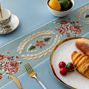 Elegant light teal table runner with red rose embroidery and golden wheat patterns