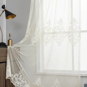 Elegant white semi-sheer curtain with baroque floral embroidery and wavy scalloped edges