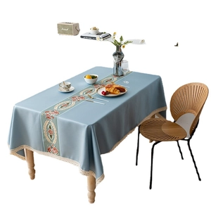 Light blue rectangular tablecloth with lace edges and vintage floral wreath pattern