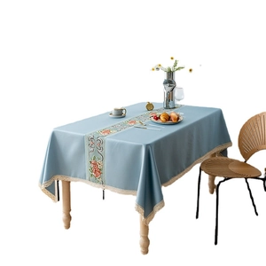 Blue rectangular fabric tablecloth with floral embroidery and white lace edges