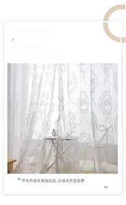 Detail of white lace sheer curtain with vintage floral embroidery and ruffle edges