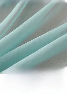 Detailed texture of thick light blue blackout curtain fabric with elegant silk sheen