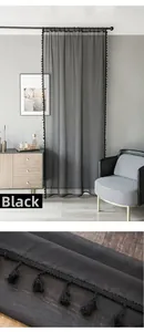 Detail of semi-transparent black sheer curtain with delicate pom-pom fringe trim