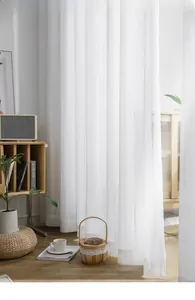 Close-up of white semi-transparent lace curtain featuring intricate vertical stripe patterns