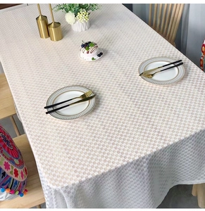 Macro detail of high-quality cream checkered tablecloth with fine woven fabric texture