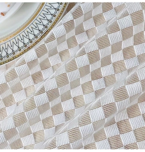 Detail of beige checkered mesh tablecloth fabric with delicate diamond weave texture