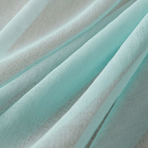 Light blue sheer curtain fabric with elegant woven texture and soft draping effect