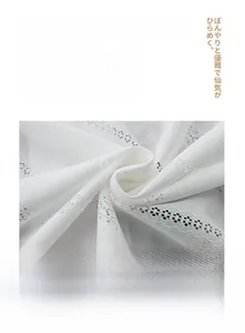 Detail of white Japanese lace curtain showing heavy hollow-out mesh and machine washable fabric