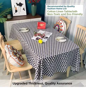 Detail of cotton linen tablecloth featuring a modern black and white triangle geometric pattern