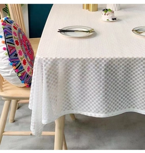 Detail of white waffle texture tablecloth on a wooden table with bohemian decor