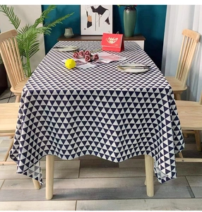 Detailed view of modern blue and white geometric triangle pattern on tablecloth fabric