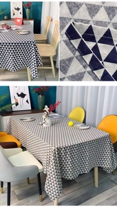 Detail view of modern geometric triangle pattern on high-quality woven linen tablecloth