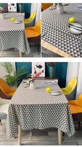 Detail view of modern minimalist gray and white geometric triangle pattern tablecloth