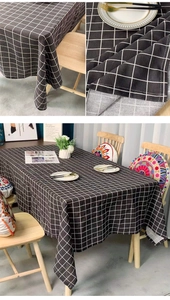 Close-up of black and white plaid tablecloth fabric texture and draped edge detail