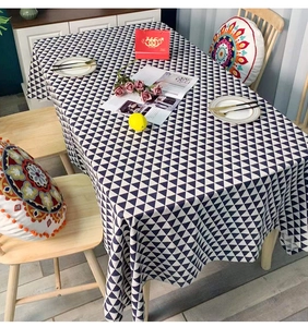 Close-up of minimalist black and white geometric triangle pattern tablecloth in a dining setting