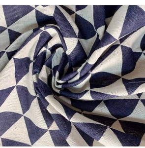 Close-up of geometric navy blue and cream cotton linen tablecloth fabric texture