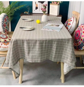 Detailed view of gray and white plaid tablecloth with soft texture on a wooden dining table