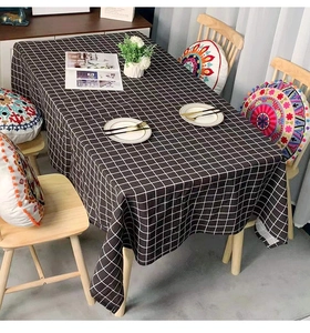Detailed view of black and white checkered tablecloth on a rectangle dining table