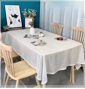 Close-up of geometric pattern on cream rectangle tablecloth with minimalist home decor