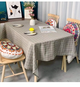 Detail showing high-quality grey plaid linen tablecloth with elegant white grid pattern