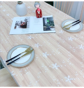 Close-up of elegant floral embroidery and delicate lace edges on white mesh tablecloth