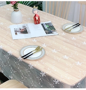 Detailed close-up of Nordic white lace tablecloth with small flower embroidery on wood table