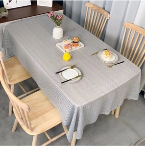 Detail of grey rectangular tablecloth featuring a textured Greek Key geometric pattern