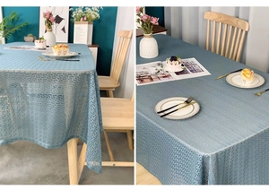 Detailed view of grey-blue luxury tablecloth with golden geometric jacquard patterns