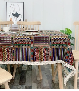 Detailed texture of bohemian zigzag pattern tablecloth with elegant white lace trim