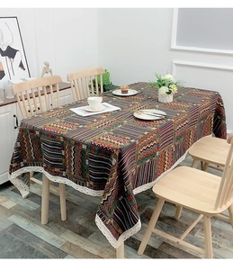 Detail of bohemian patterned tablecloth with colorful stripes and white lace edges