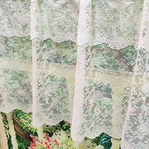 White lace cafe curtain with vintage floral patterns and scalloped edges for window decor