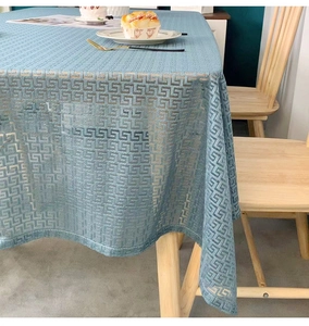 Detail of light blue tablecloth featuring an elegant Greek key jacquard pattern