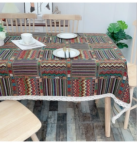 Detail of bohemian geometric tablecloth with vibrant patterns and elegant white lace trim