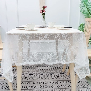 Nordic white lace tablecloth with floral mesh embroidery on rectangular wooden table