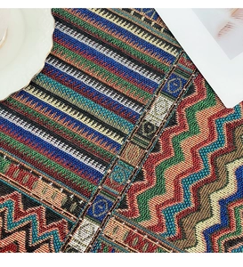 Macro shot of ethnic style woven tablecloth with colorful zigzag and geometric patterns