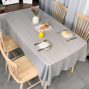 Grey rectangular tablecloth with textured geometric pattern in a modern dining setting