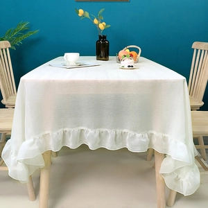 Minimalist white ruffled tablecloth with elegant frill edges for rectangular tables