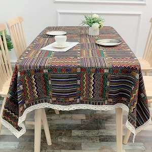 Ethnic bohemian colorful table cloth with lace trim on a bright dining room setting