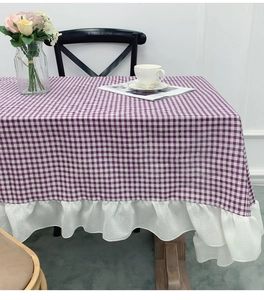 Detail of purple plaid cotton linen tablecloth with elegant white ruffled lace edge trim