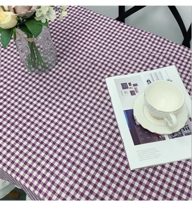 Detail of purple and white checkered tablecloth fabric with fine cotton linen texture