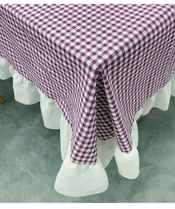 Detailed view of purple plaid tablecloth with double-layer white ruffle lace edges
